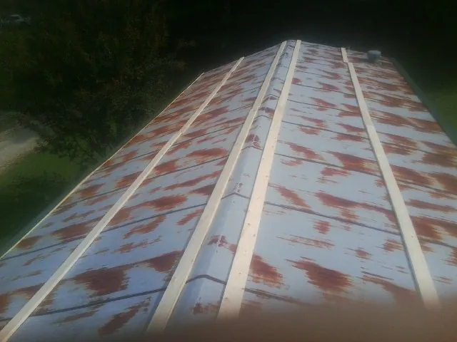 Rusted metal roof panels with new wood purlins before replacement — Storm Damage Roof Repair in Coyote by Roofing Brothers